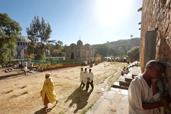 Pilgrims walking through the historic church compound in Axum, Ethiopia