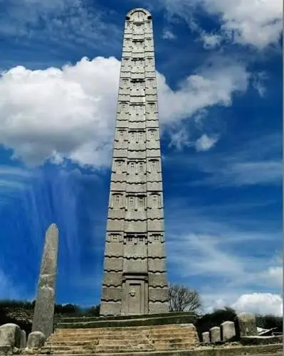 A carved granite obelisk standing among the ancient ruins of Axum, Ethiopia