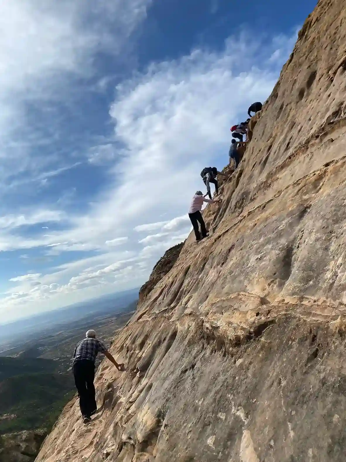 Climbing the cliff face to Abune Yemata Guh church above Hawzien, Tigray