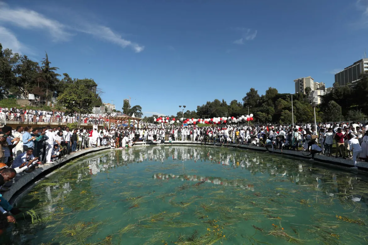 A massive crowd of Oromo worshippers gathered around a pool during the Irreecha thanksgiving celebration