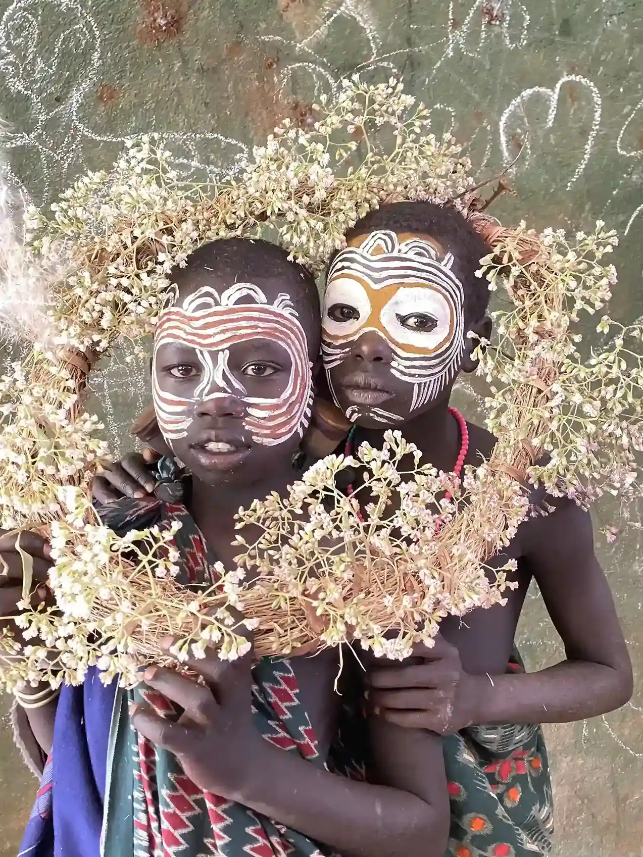 Karo tribe children with traditional face paint and flower crowns, Omo Valley, Ethiopia